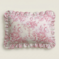 Floral patterned pillow with ruffled edge on a plain background