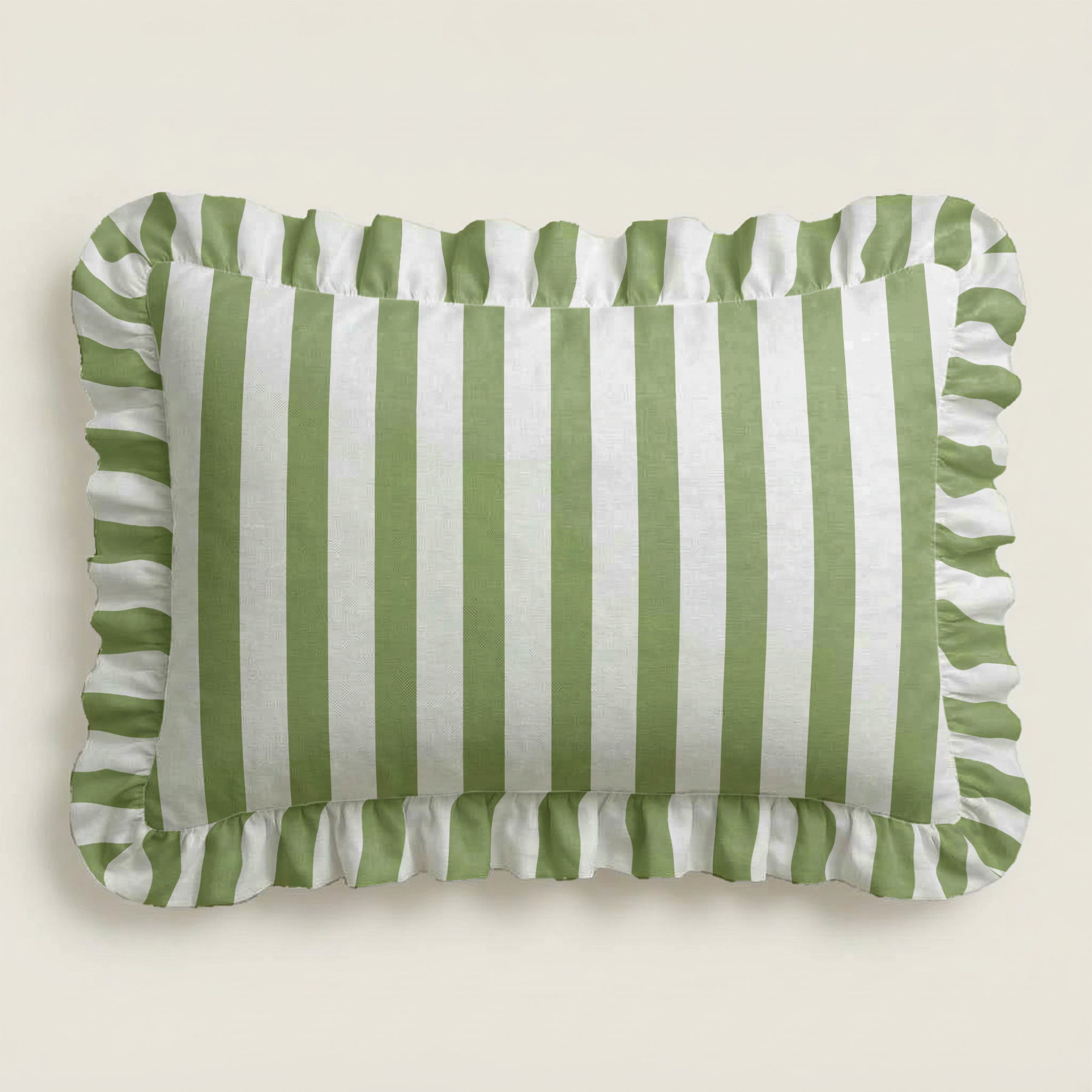 Green and white striped pillow with ruffled edges on a beige background