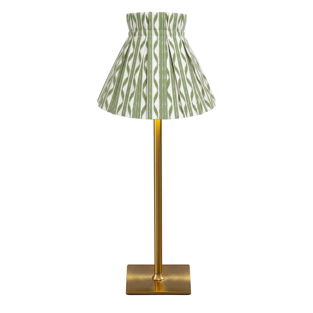 Table lamp with a green and white patterned cover shade on a white background
