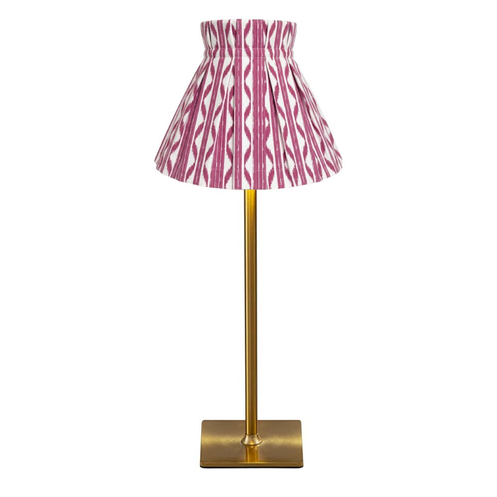 Table lamp with a pink print cover shade on a white background