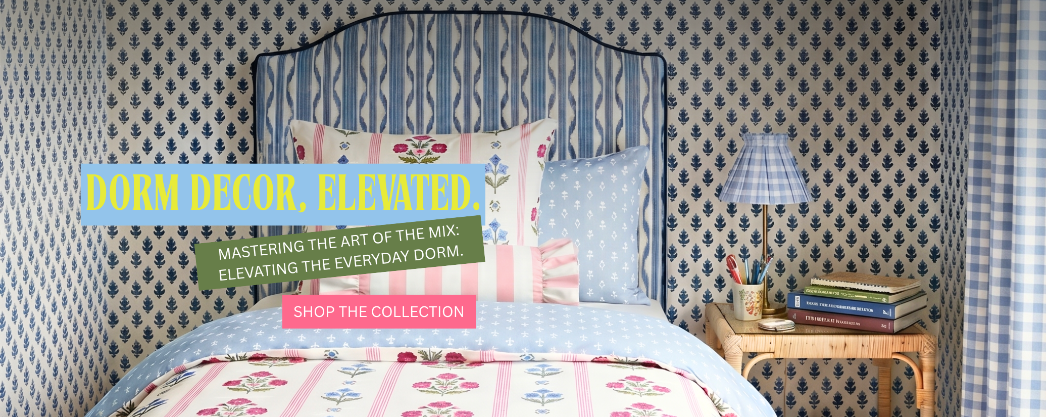 Bedroom with patterned wallpaper, bed with colorful bedding.