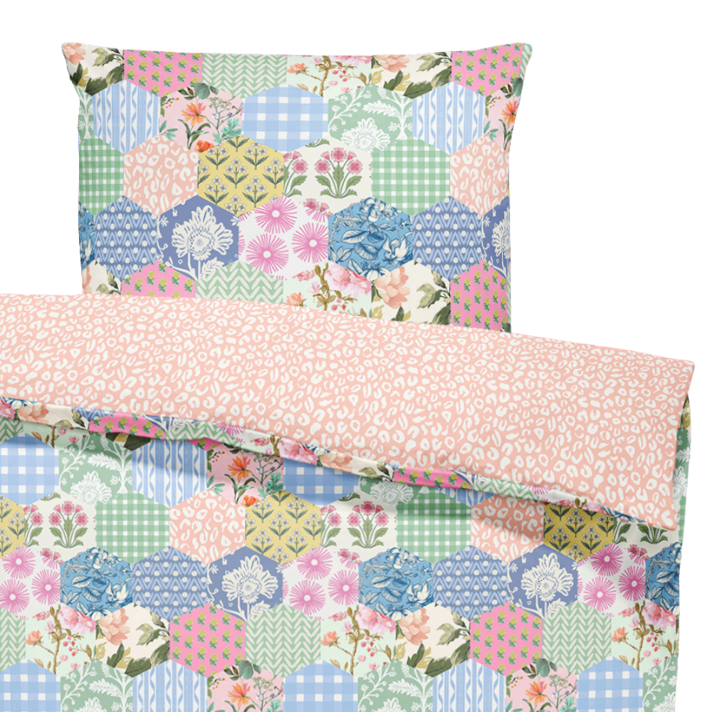 Floral and geometric patterned bedding set on a white background