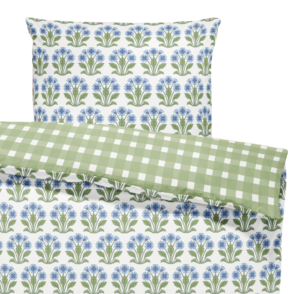 Floral and checkered patterned pillows on a white background