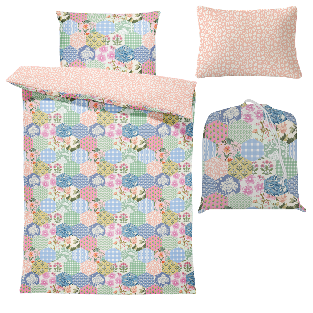 Floral patterned bedding set with matching bag on a white background