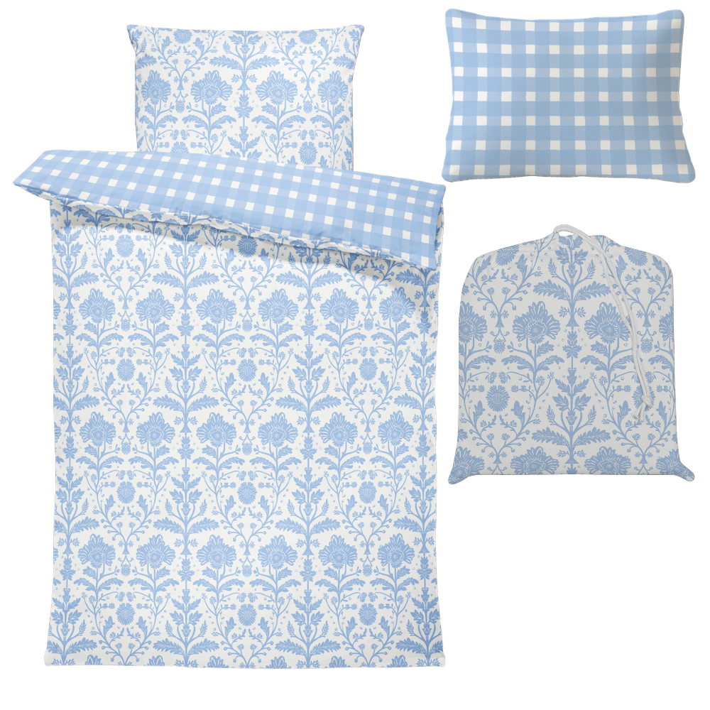 Blue and white floral and checkered patterned bedding set on a white background
