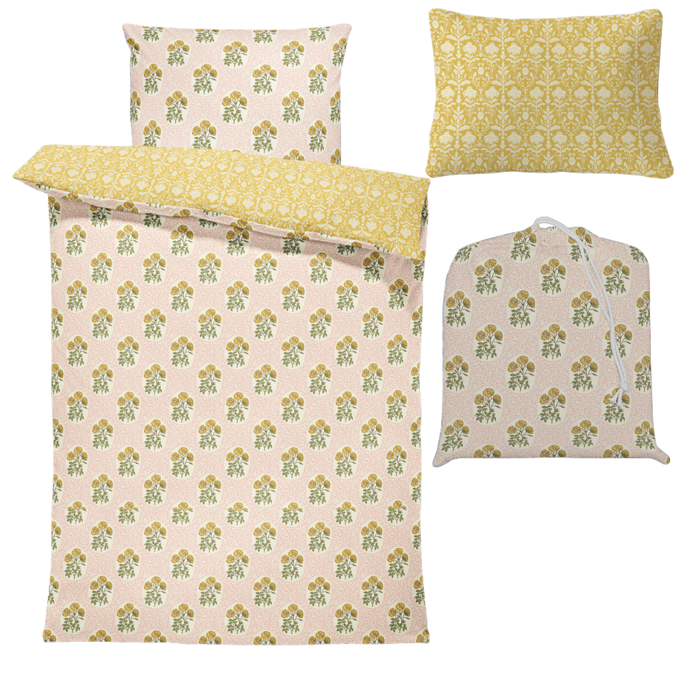 Floral bedding set with matching coverlet and pillowcases on a white background