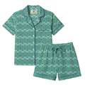 Green patterned pajama set with shirt and shorts on a white background