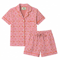 Pink and orange geometric patterned pajama set on a white background