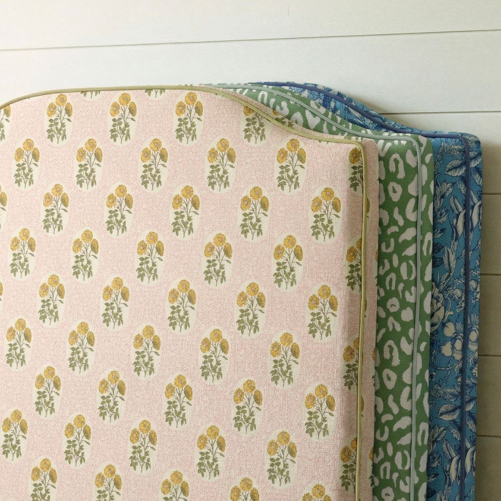 Three patterned fabrics stacked on a wooden surface