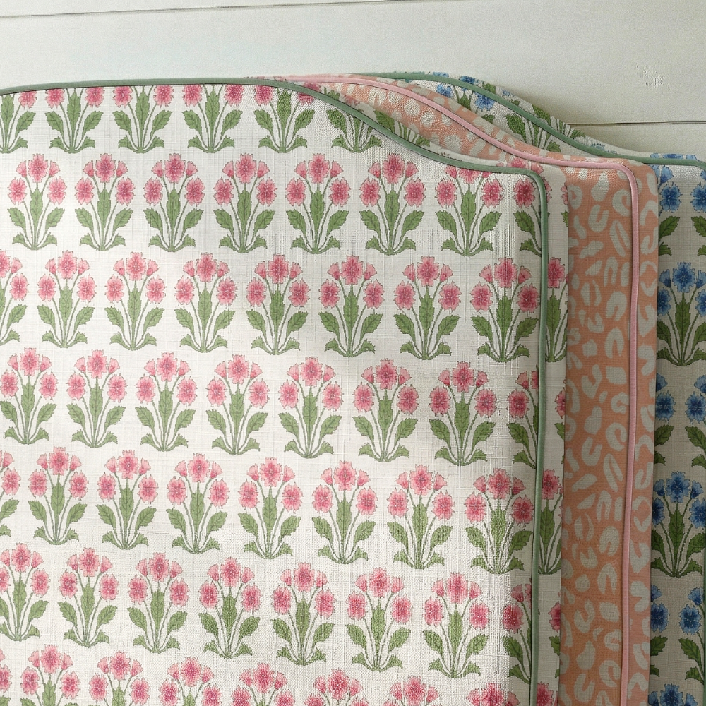 Three patterned fabrics stacked on a wooden surface