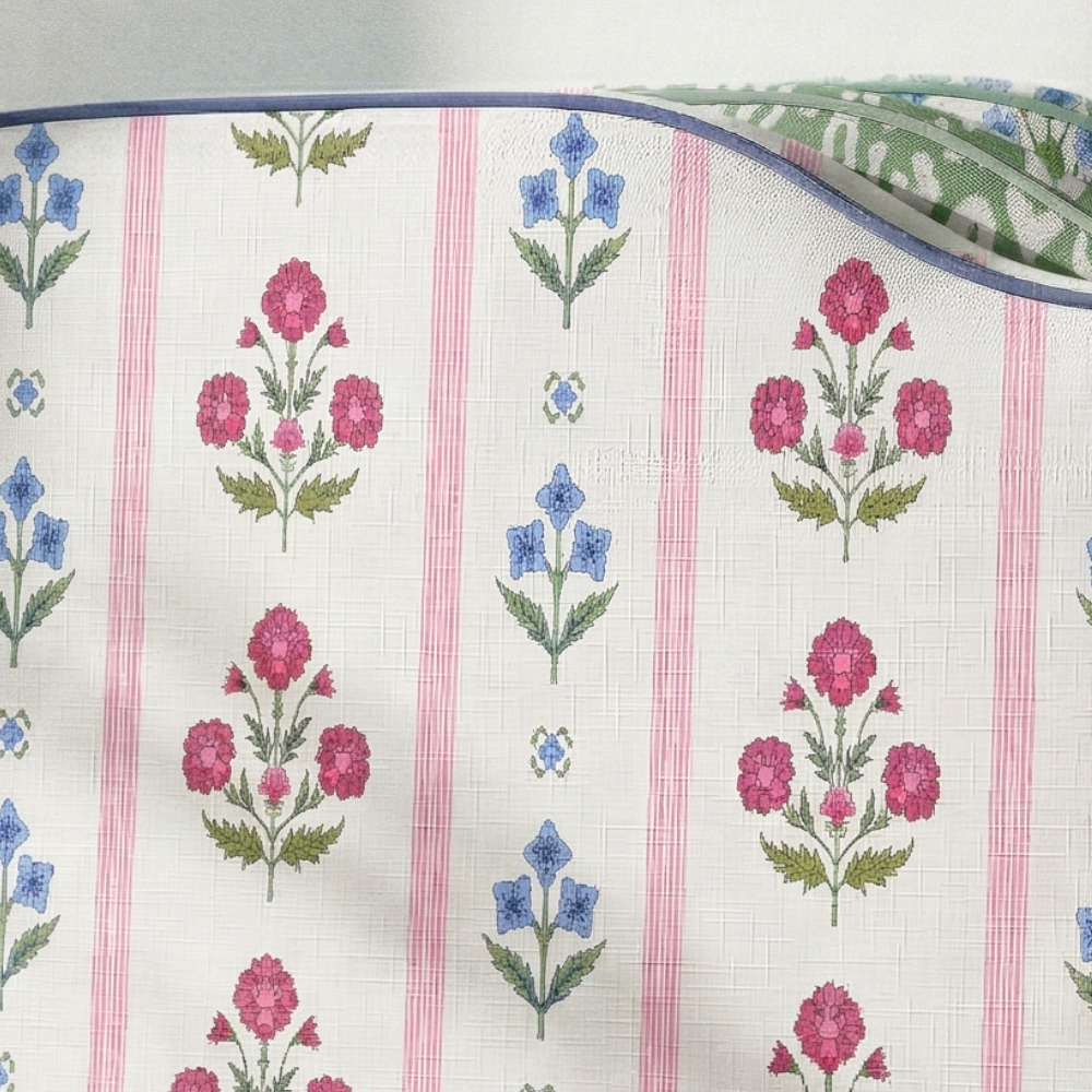 Floral embroidery pattern on fabric with pink, blue, and green colors.