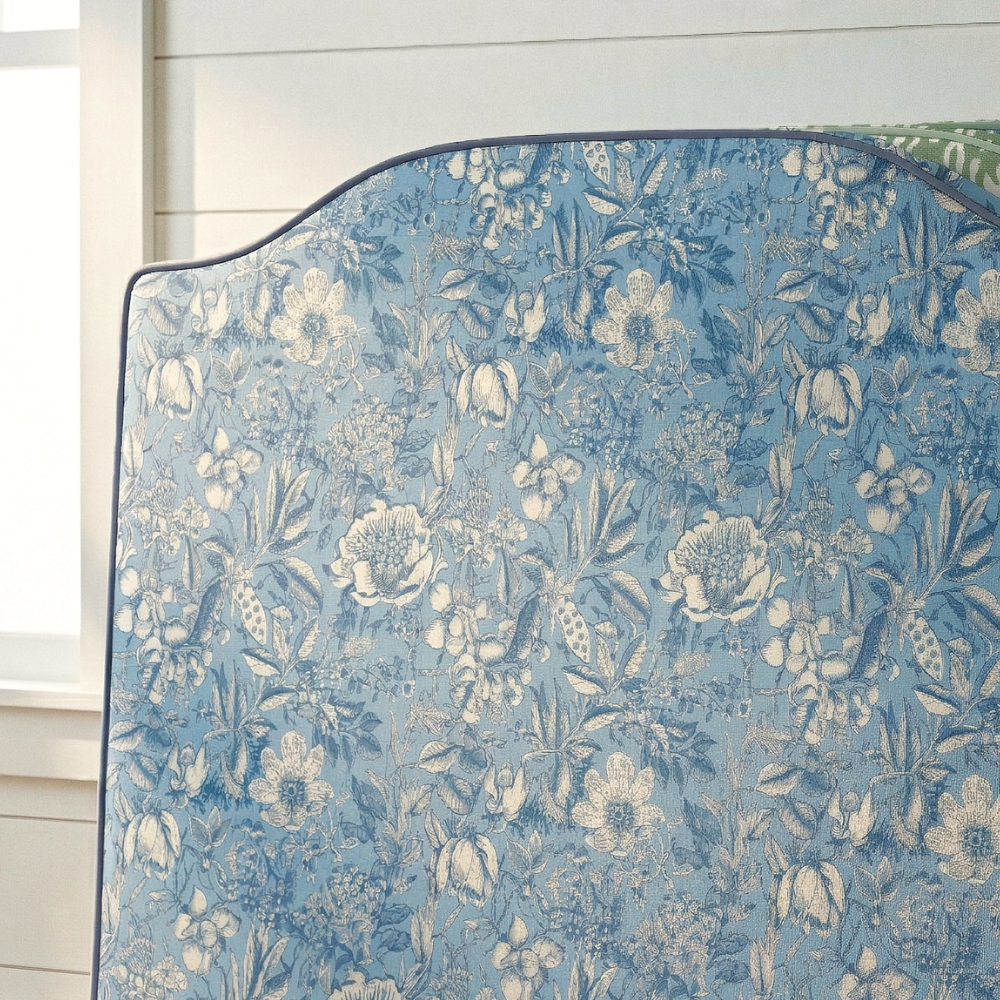 Floral patterned fabric with blue and white colors on a wooden surface.