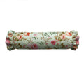 Floral patterned cylindrical pillow on a white background