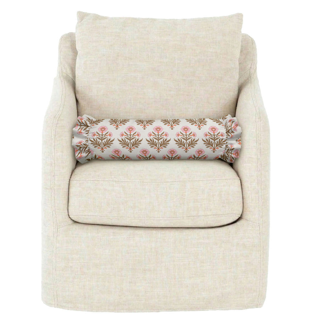 Beige armchair with a floral-patterned cylindrical pillow on a white background