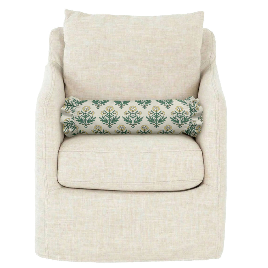 Beige armchair with a floral-patterned pillow on a white background