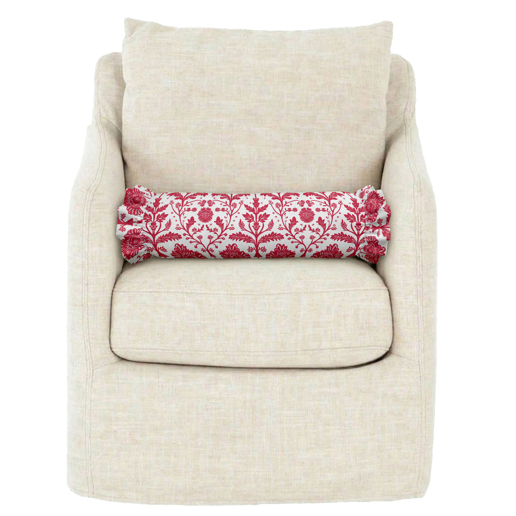 Beige armchair with a red and white patterned cylindrical pillow on a white background