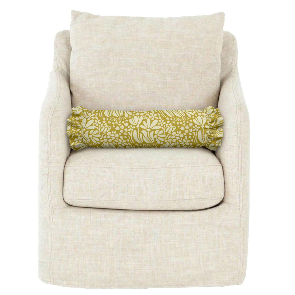 Beige armchair with a yellow floral-patterned pillow on a white background