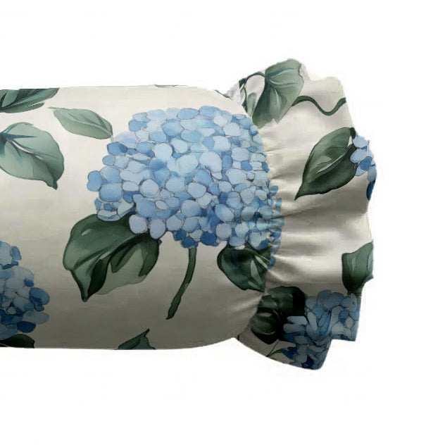 Floral-patterned pillow with blue flowers and green leaves on a white background