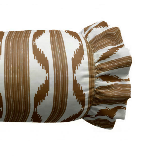 Zoom of decorative cylindrical pillow with a brown and white pattern on a white background