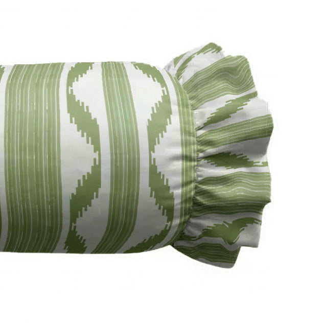 Zoom of decorative cylindrical pillow with a green and white pattern on a white background