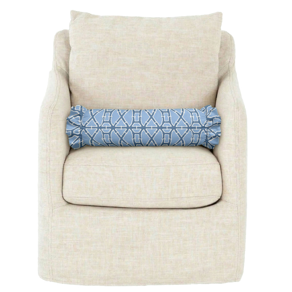 Beige armchair with a blue patterned pillow on a white background