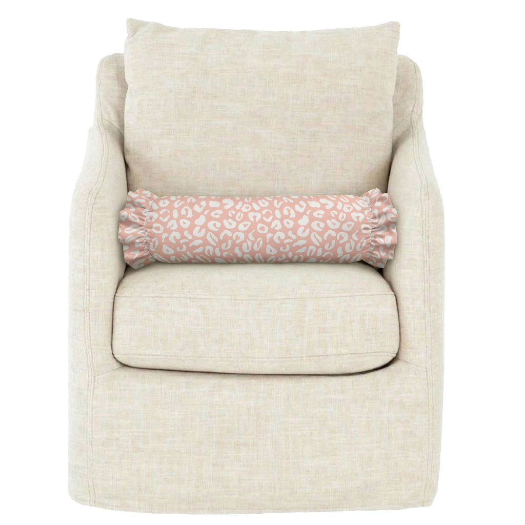Beige armchair with a pink patterned pillow on a white background