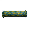Rolled-up fabric with green and yellow pattern on a white background