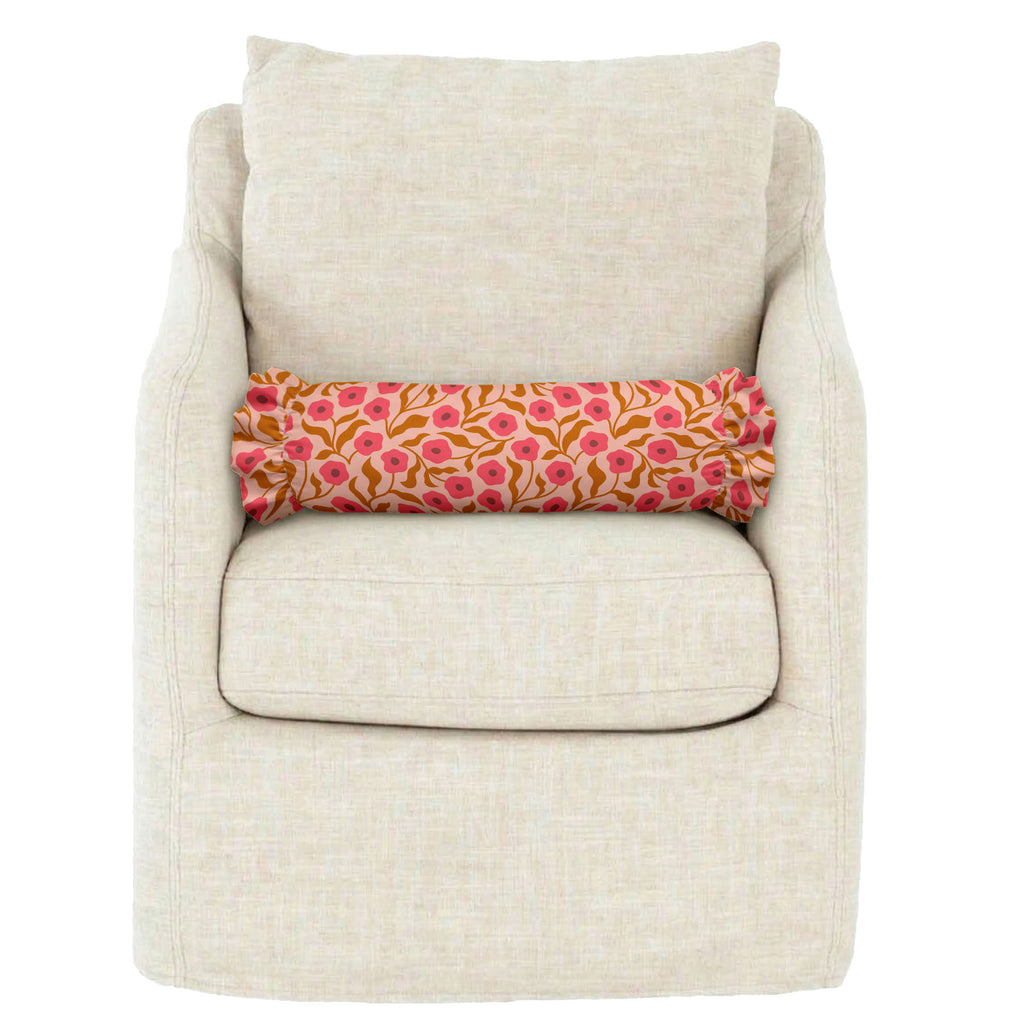 Beige armchair with a floral-patterned cushion on a white background