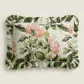 Floral and leaf patterned pillow on a light background