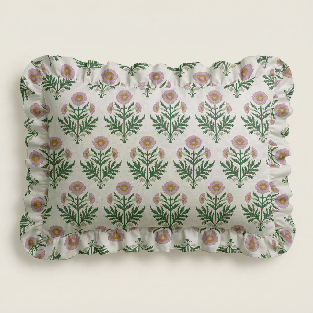 Floral patterned pillow with ruffled edge on a light background