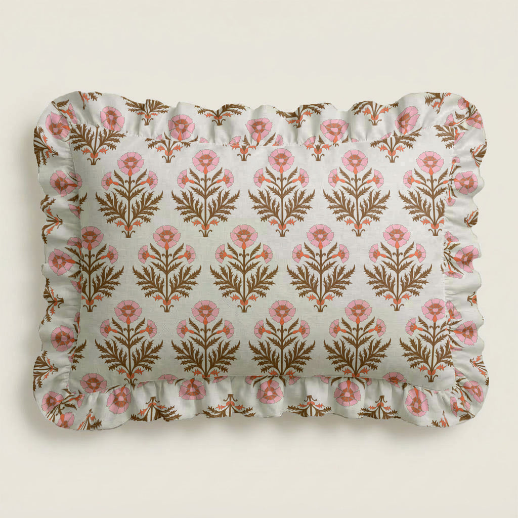 Floral patterned pillow with ruffled edge on a light background