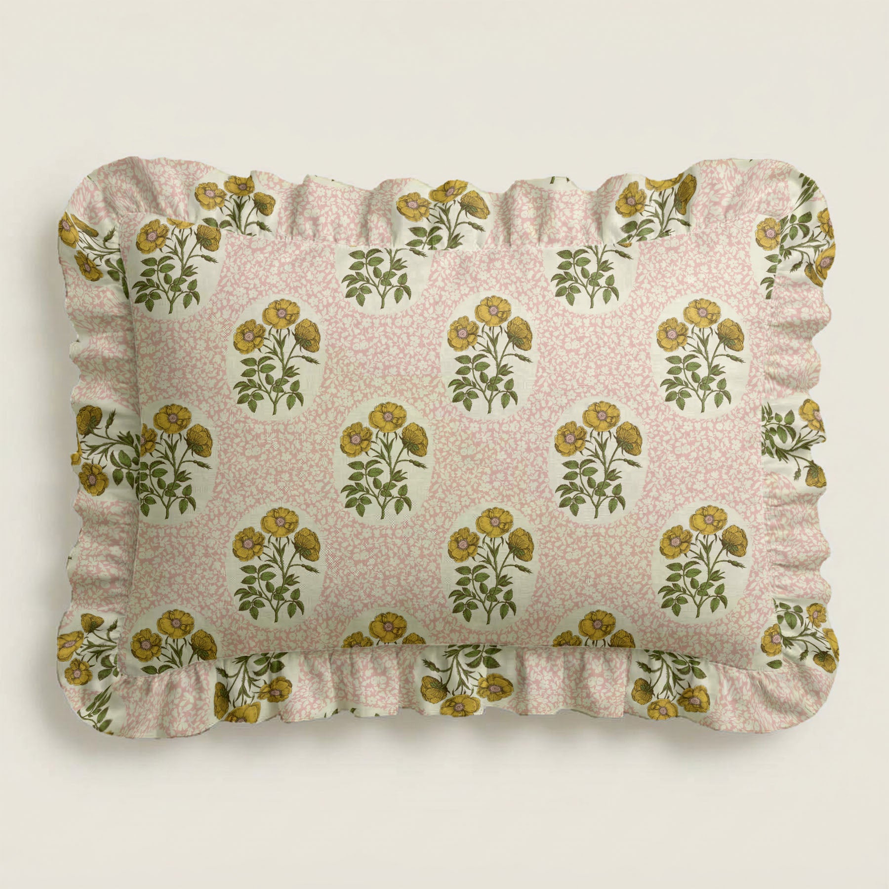 Floral patterned pillow with ruffled edges on a light background