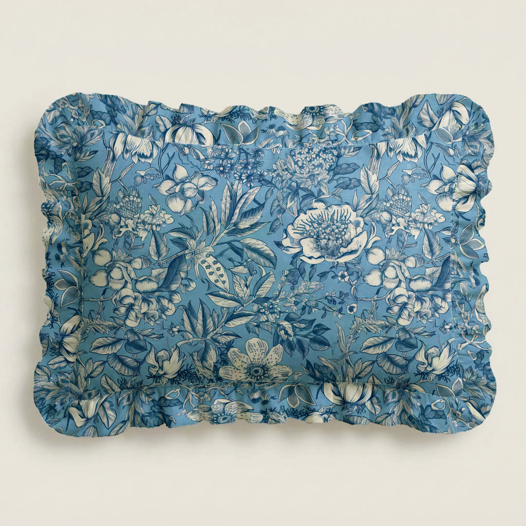 Floral patterned blue pillow on a light beige background