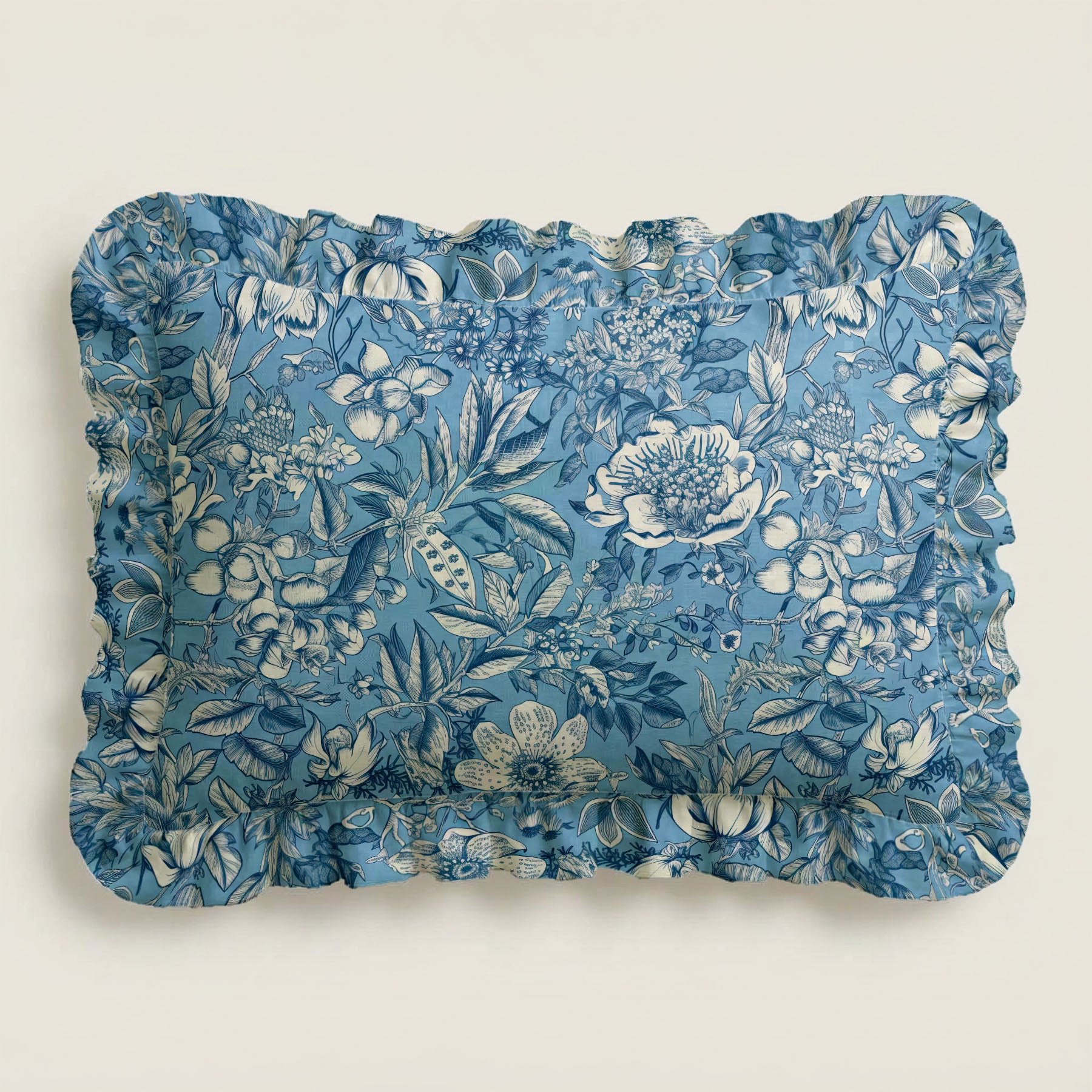 Floral patterned blue pillow on a light beige background