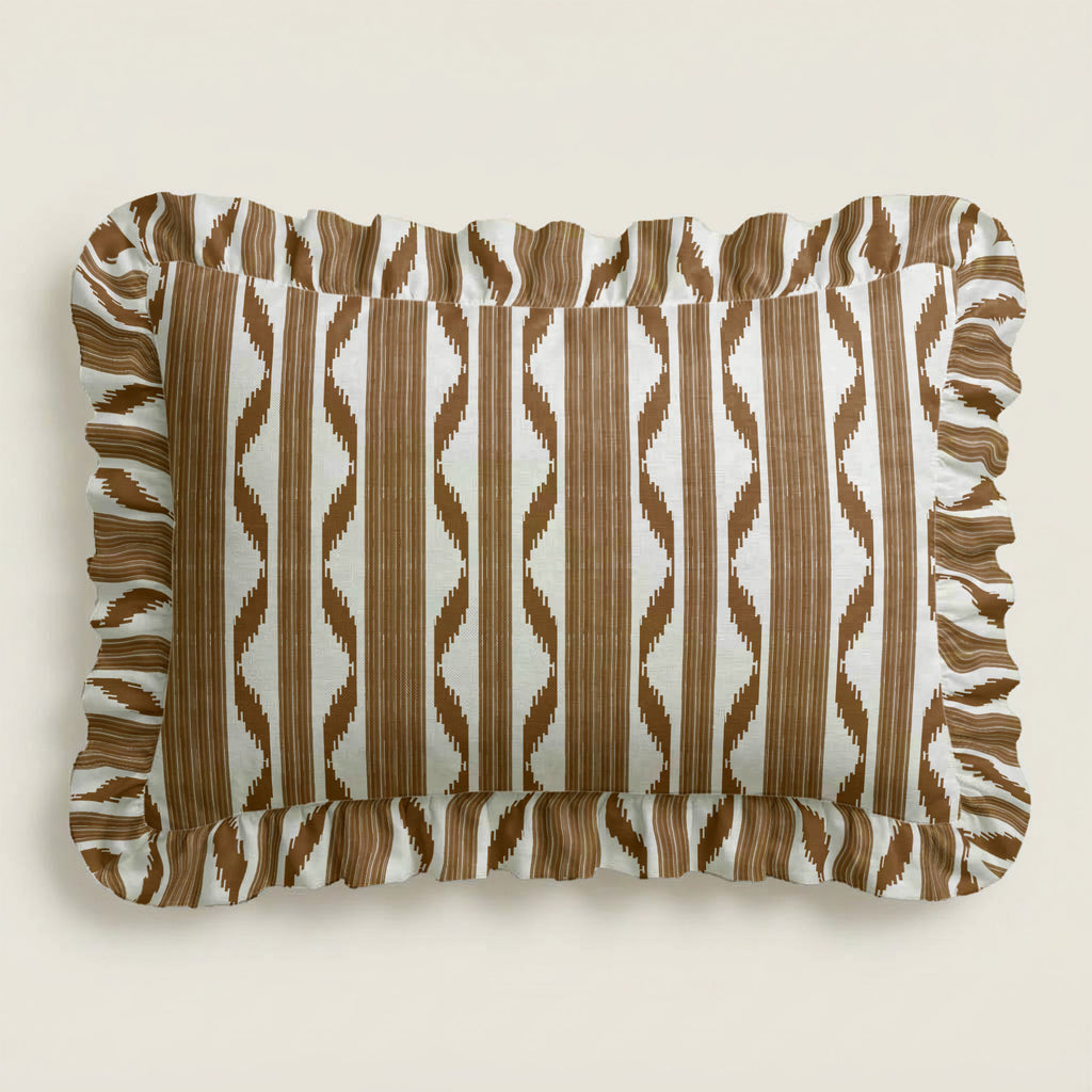 Rectangular pillow with brown and white striped pattern on a beige background