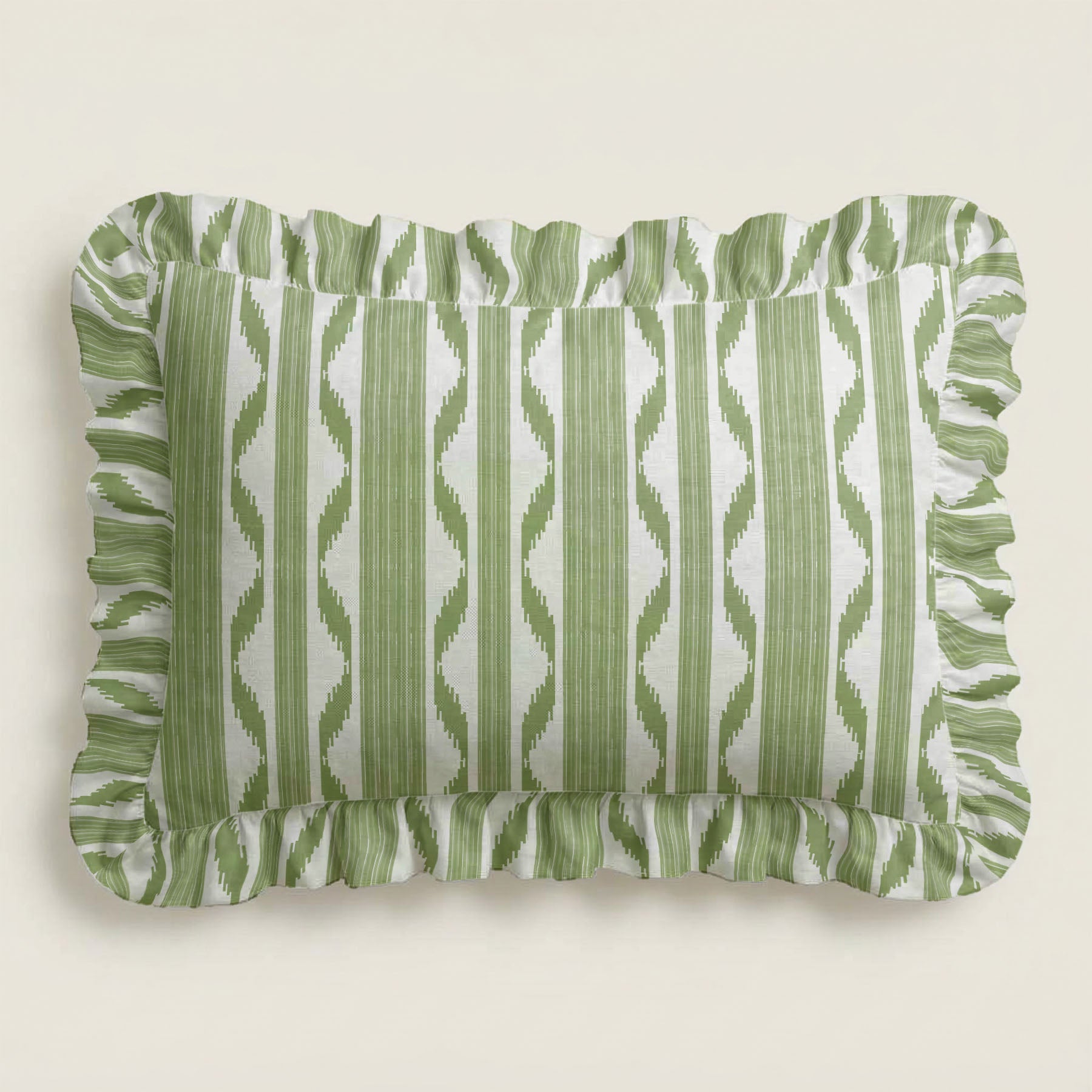 Green and white striped pillow with ruffled edges on a beige background