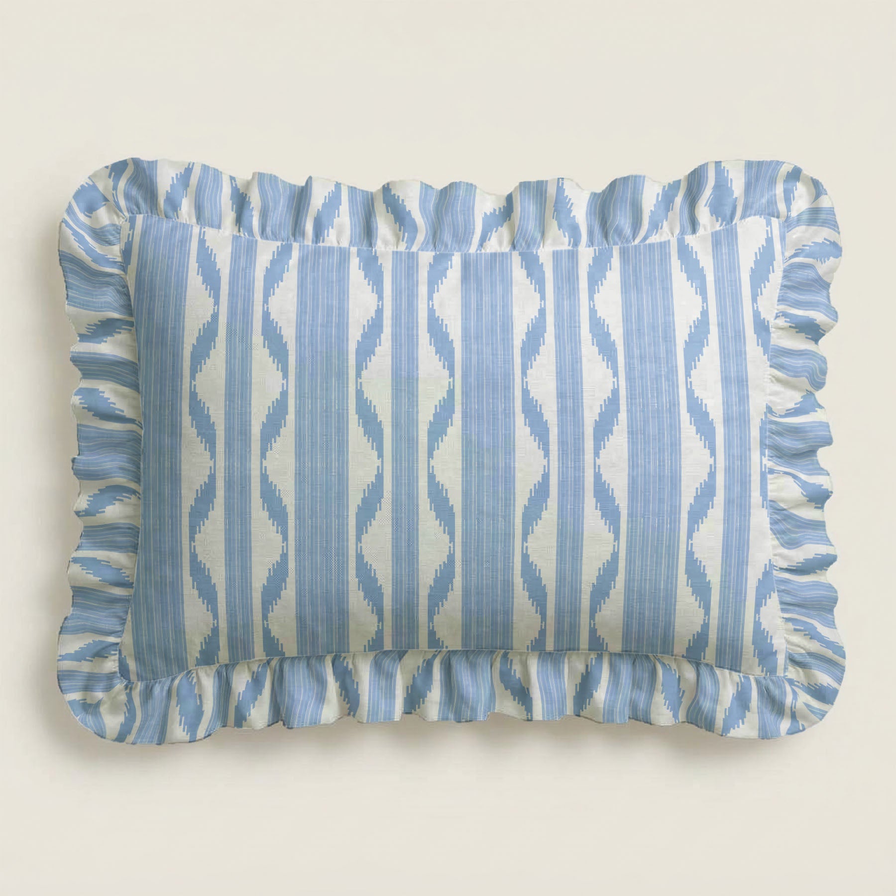 Rectangular pillow with blue and white striped pattern on a beige background