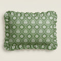 Green fabric with white floral pattern on a beige background