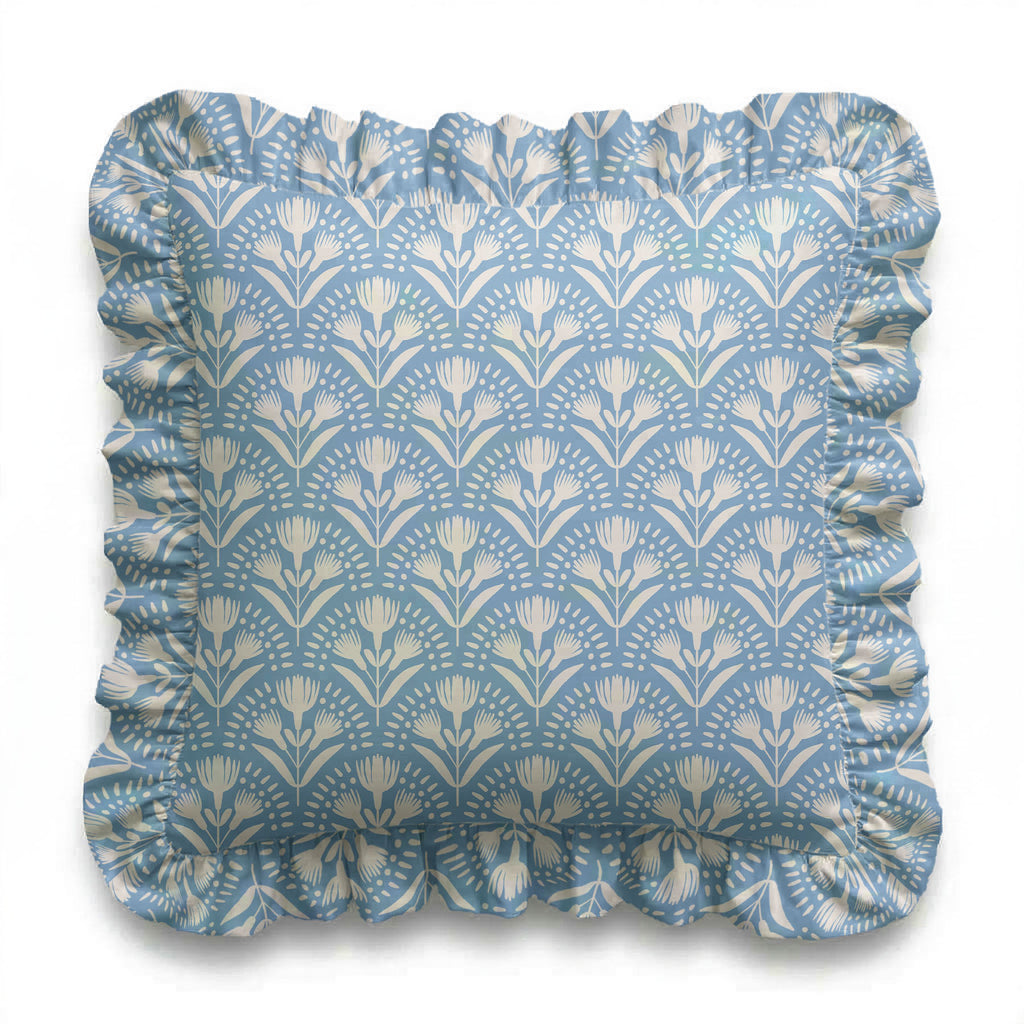 Decorative pillow with floral pattern and ruffled edge on a white background