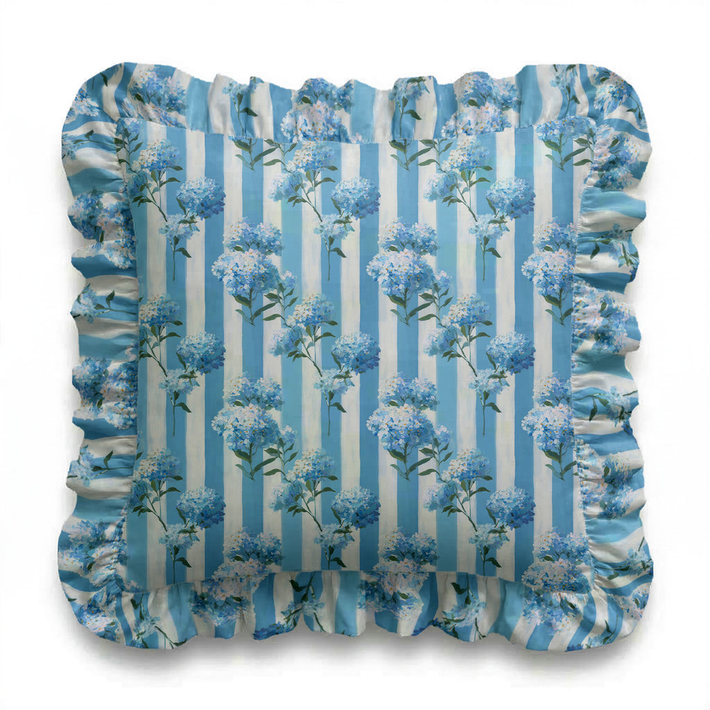Decorative pillow with blue floral pattern on a striped background