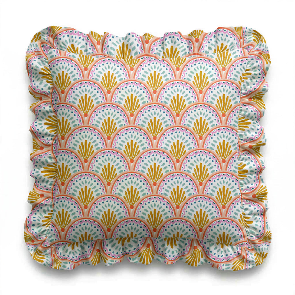 Decorative pillow with a colorful shell pattern on a white background