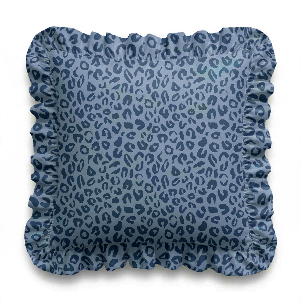 Blue patterned cushion with ruffled edge on a white background