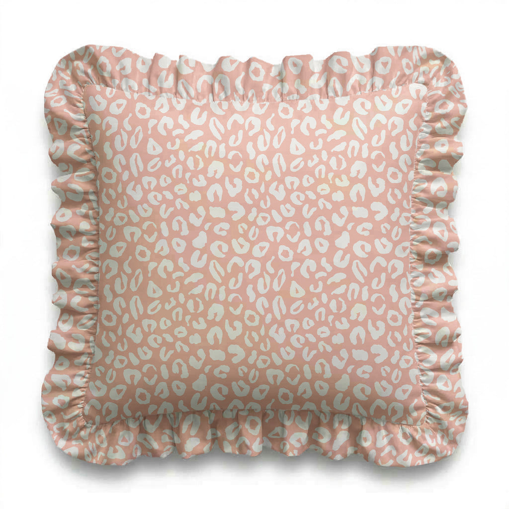 Pink pillow with white leopard print pattern on a white background