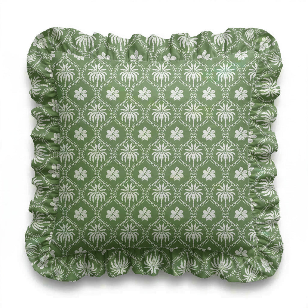 Green cushion with white floral pattern on a white background