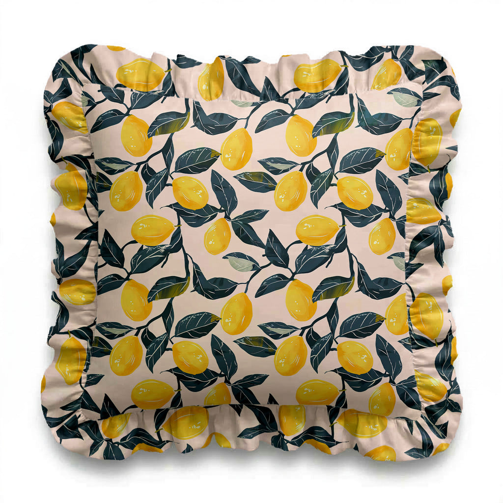 Decorative pillow with lemon and leaf pattern on a white background