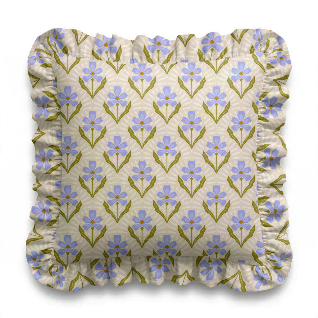 Floral patterned cushion with blue flowers and green leaves on a beige background