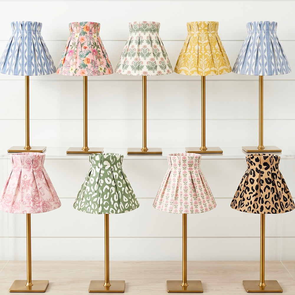 Row of small lamps with colorful fabric-cover shades on a wooden floor.
