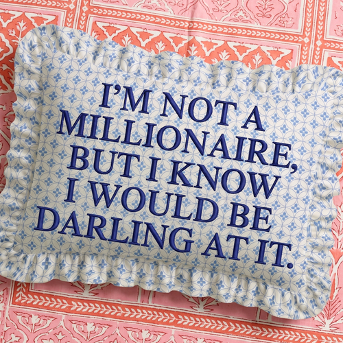 Decorative pillow with blue text on a floral patterned background