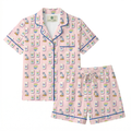 Pink pajama set with cartoon character pattern on a white background