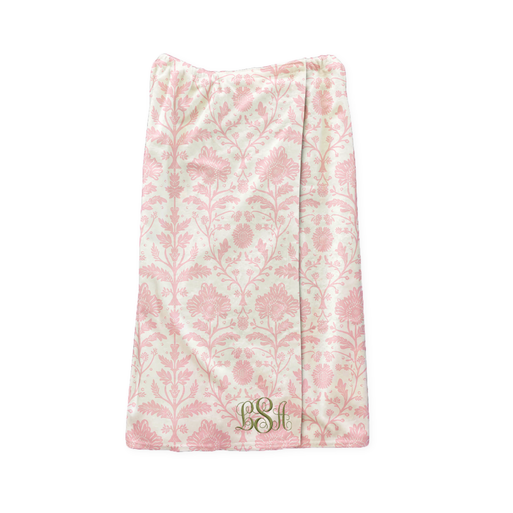 Floral patterned wrap towel with initials on a white background